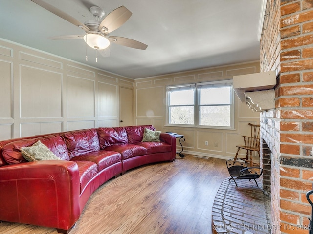 614 Oak Ridge Dr, Sand Springs, OK 74063 - living area featuring a decorative wall, wood finished floors, and ceiling fan