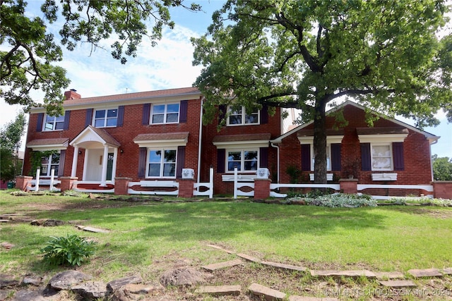 614 Oak Ridge Dr, Sand Springs, OK 74063 - view of front facade with brick siding, a chimney, a front yard, and a porch