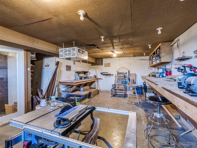614 Oak Ridge Dr, Sand Springs, OK 74063 - miscellaneous room with a workshop area, unfinished concrete floors, and a heating unit