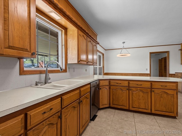 kitchen featuring brown cabinetry, dishwasher, a sink, and light countertops