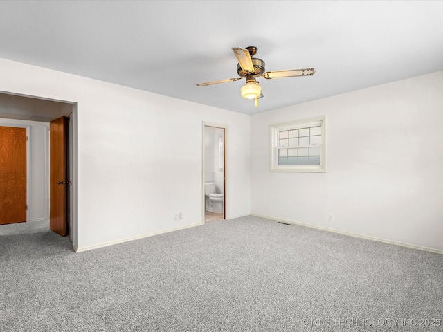 unfurnished room with visible vents, ceiling fan, carpet flooring, and baseboards