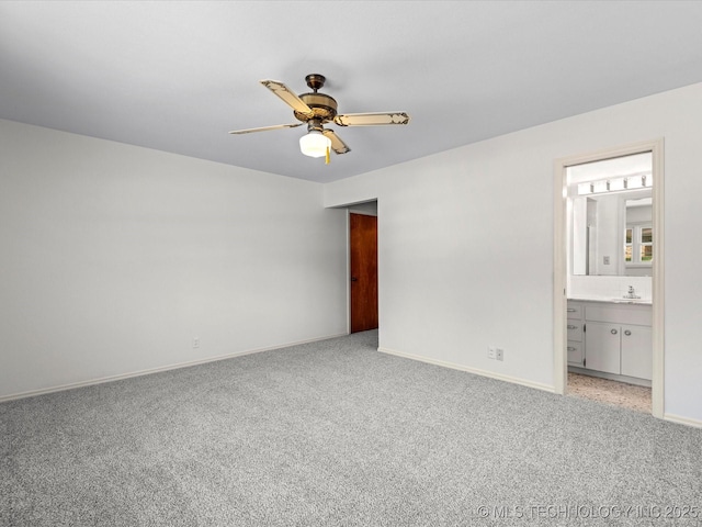 unfurnished bedroom featuring ceiling fan, light carpet, ensuite bathroom, and baseboards