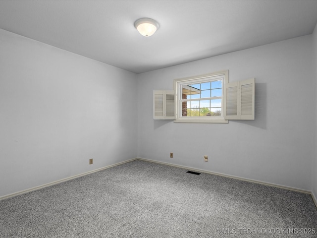carpeted spare room with visible vents and baseboards