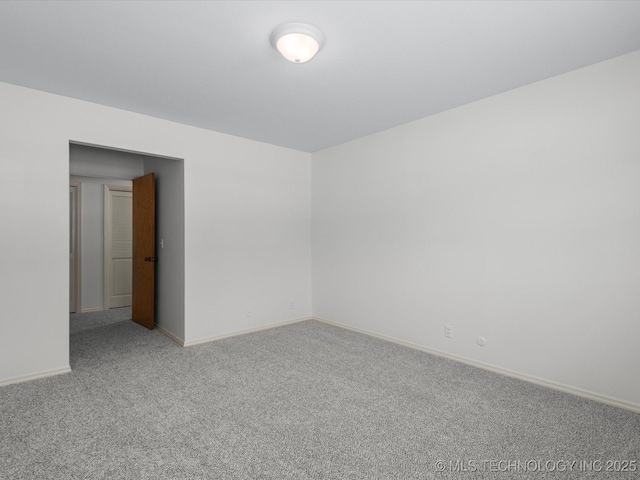 empty room with baseboards and carpet floors