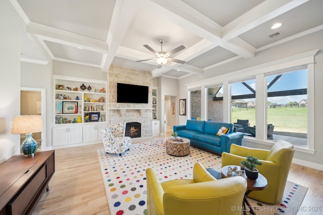 living room featuring light wood finished floors, visible vents, beamed ceiling, and coffered ceiling