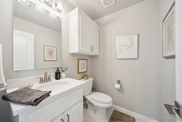 half bathroom with vanity, baseboards, tile patterned flooring, toilet, and visible vents