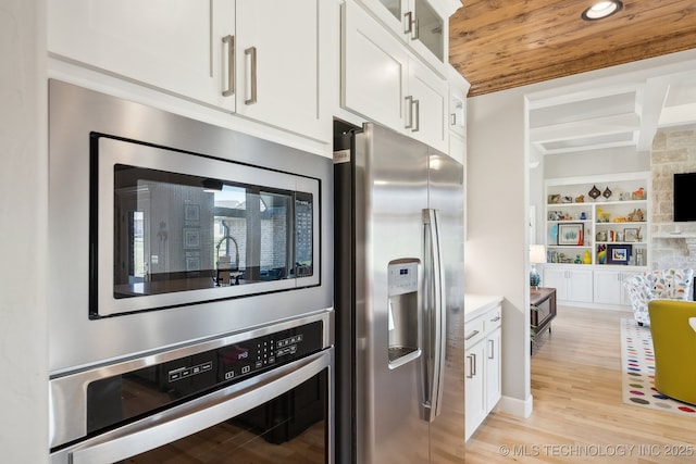 kitchen featuring built in features, light wood-type flooring, wood ceiling, white cabinetry, and stainless steel appliances