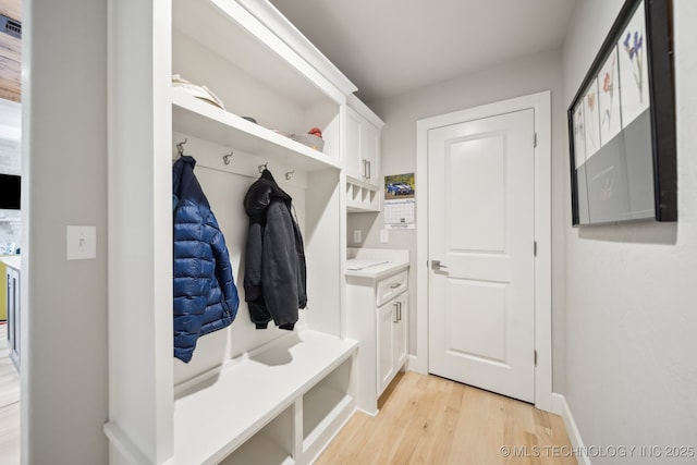 mudroom featuring light wood-style flooring and baseboards