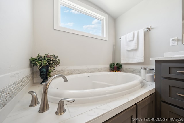 bathroom featuring a bath and vanity