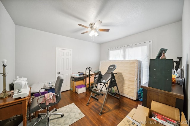 office with a ceiling fan and wood finished floors