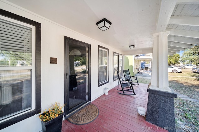 wooden terrace featuring covered porch