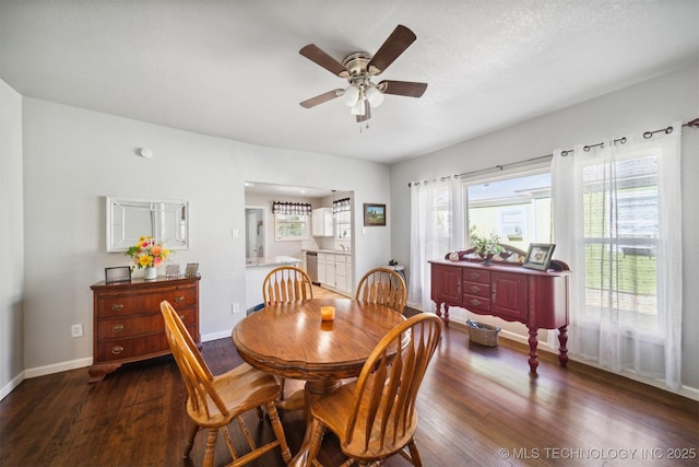 dining area featuring ceiling fan, a textured ceiling, wood finished floors, and baseboards