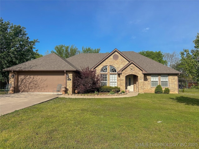 french country style house featuring a shingled roof, a garage, brick siding, a front lawn, and driveway