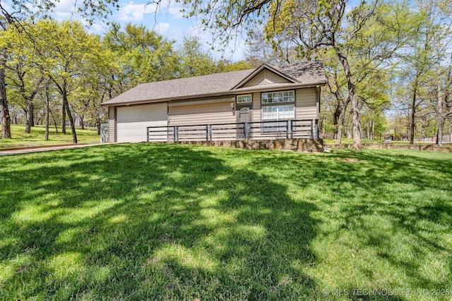 2667 Duguid Ln, Kingston, OK 73439 - view of front facade featuring a front lawn, an attached garage, and a shingled roof