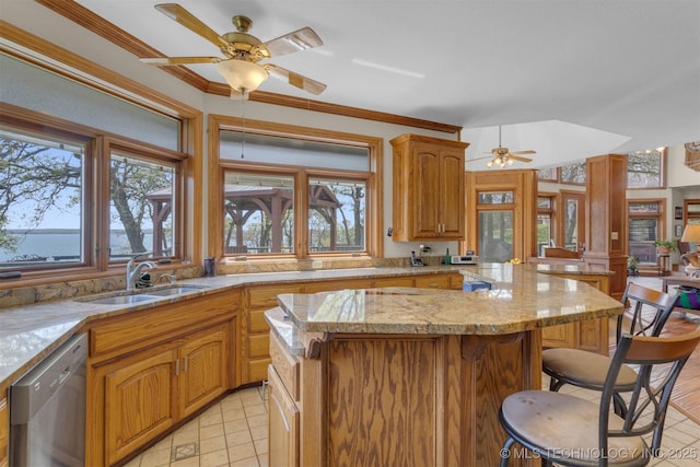 2667 Duguid Ln, Kingston, OK 73439 - kitchen with stainless steel dishwasher, a sink, a kitchen island, a ceiling fan, and a breakfast bar area