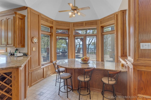 2667 Duguid Ln, Kingston, OK 73439 - sunroom / solarium featuring vaulted ceiling, tile patterned floors, a decorative wall, and wood walls