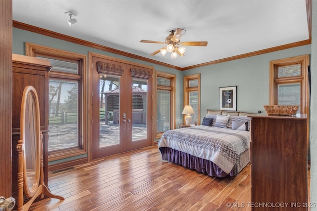 2667 Duguid Ln, Kingston, OK 73439 - bedroom with french doors, access to outside, wood finished floors, and crown molding