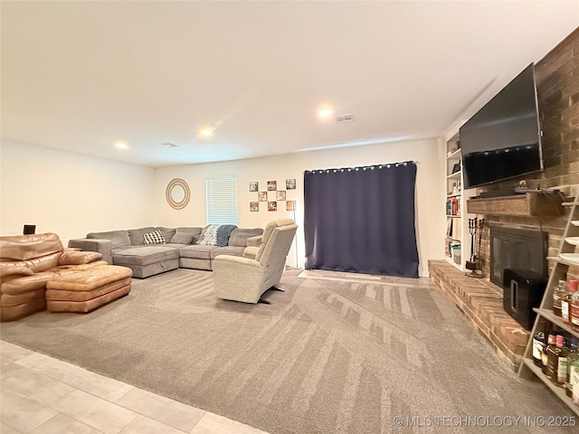 carpeted living area featuring recessed lighting, built in shelves, a brick fireplace, and visible vents