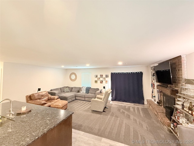 living room with a brick fireplace and recessed lighting