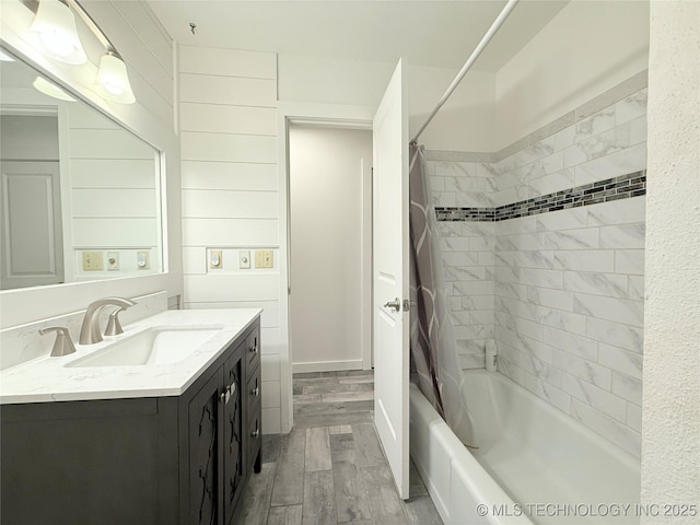 full bath with shower / tub combo, vanity, and wood finished floors