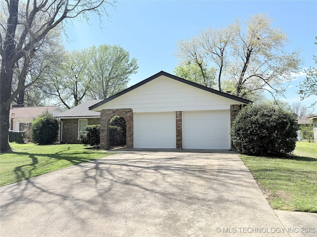 view of front of property with brick siding, a front lawn, an attached garage, and concrete driveway