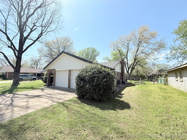 view of home's exterior featuring a chimney, brick siding, a garage, fence, and a lawn