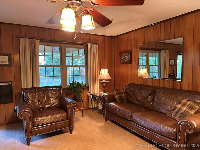 10348 W 805th Rd, Fort Gibson, OK 74434 - living room with light colored carpet, wooden walls, ceiling fan, and a wealth of natural light