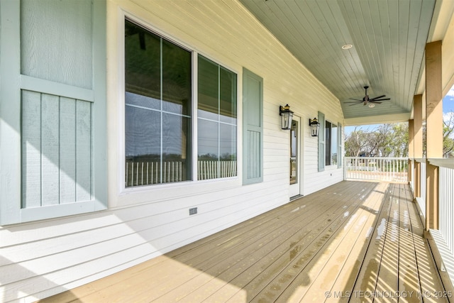 wooden deck featuring a porch and a ceiling fan
