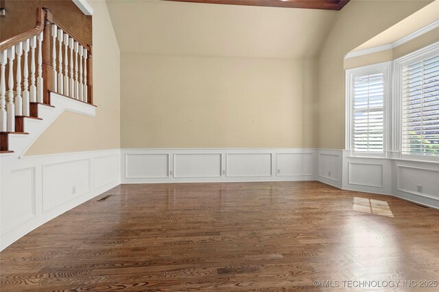 7505 S 4th St, Broken Arrow, OK 74011 - empty room featuring lofted ceiling, a wainscoted wall, a decorative wall, wood finished floors, and stairs