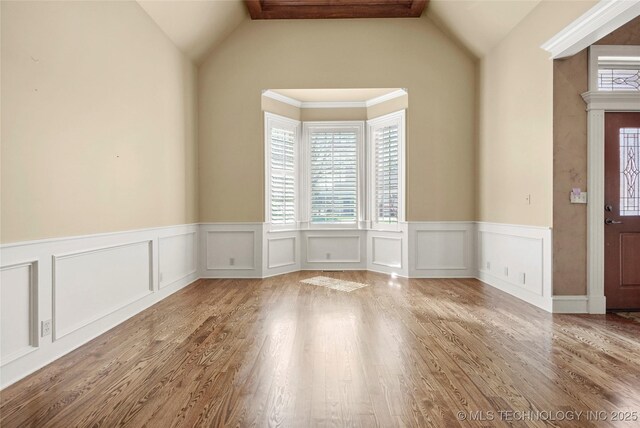 7505 S 4th St, Broken Arrow, OK 74011 - spare room with plenty of natural light, wainscoting, a decorative wall, wood finished floors, and lofted ceiling