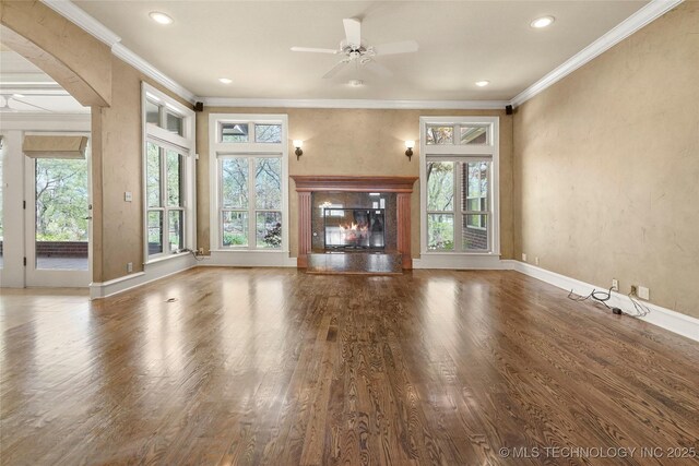 7505 S 4th St, Broken Arrow, OK 74011 - unfurnished living room featuring a ceiling fan, ornamental molding, wood finished floors, a glass covered fireplace, and recessed lighting