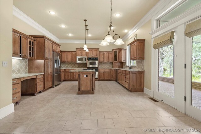 7505 S 4th St, Broken Arrow, OK 74011 - kitchen with appliances with stainless steel finishes, crown molding, brown cabinets, a kitchen island, and backsplash