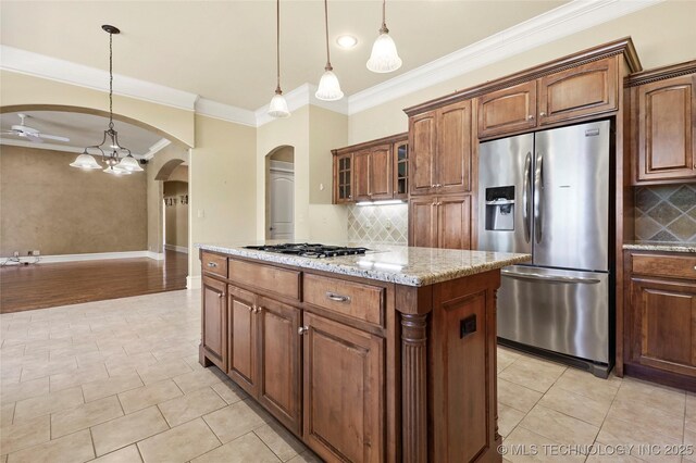 7505 S 4th St, Broken Arrow, OK 74011 - kitchen with stainless steel appliances, crown molding, arched walkways, a kitchen island, and light stone counters