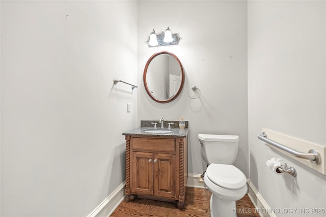 7505 S 4th St, Broken Arrow, OK 74011 - half bath with wood finished floors, toilet, vanity, and baseboards