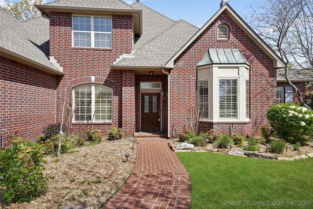 7505 S 4th St, Broken Arrow, OK 74011 - view of front facade featuring brick siding, roof with shingles, and a front lawn