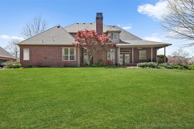 7505 S 4th St, Broken Arrow, OK 74011 - back of house featuring a lawn, brick siding, a chimney, and a shingled roof