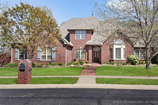 7505 S 4th St, Broken Arrow, OK 74011 - traditional-style house with brick siding, a front lawn, and roof with shingles