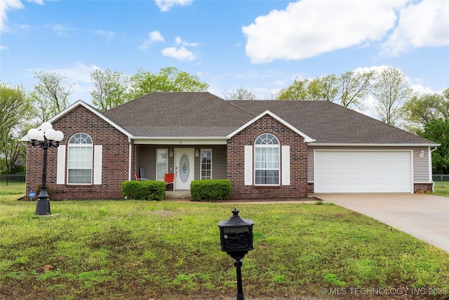 single story home with brick siding, a front lawn, a garage, and concrete driveway