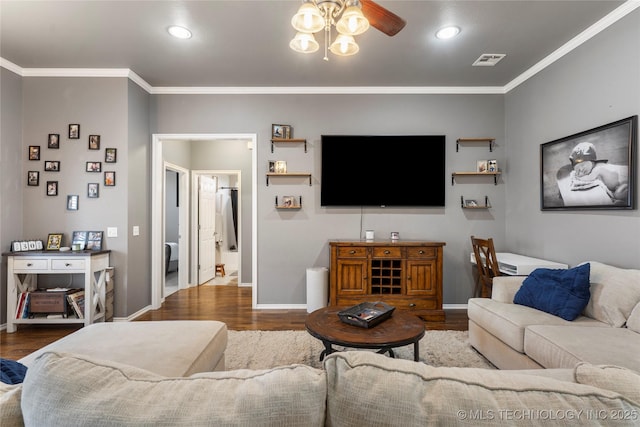 living room with crown molding, visible vents, a ceiling fan, and wood finished floors