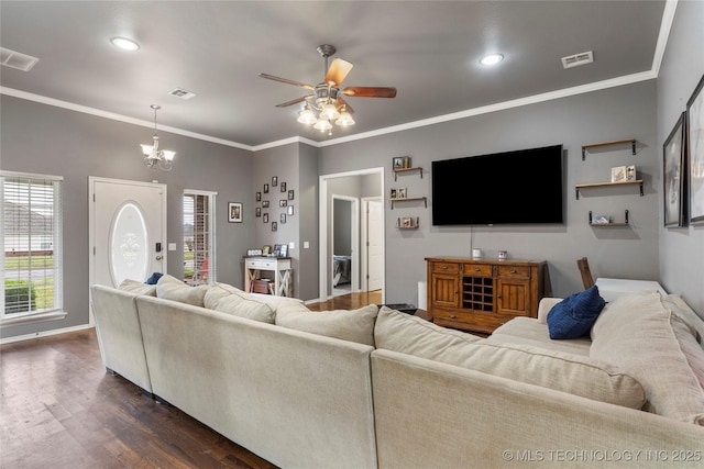 living area with ceiling fan with notable chandelier, dark wood finished floors, and visible vents
