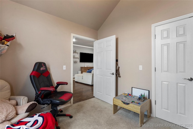 carpeted office featuring lofted ceiling