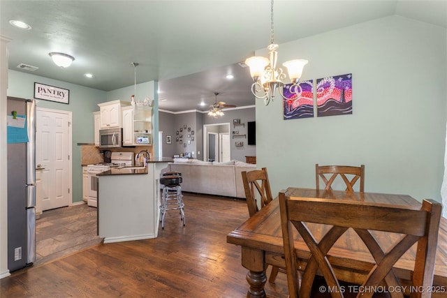 dining space featuring dark wood-type flooring, ceiling fan with notable chandelier, visible vents, and recessed lighting