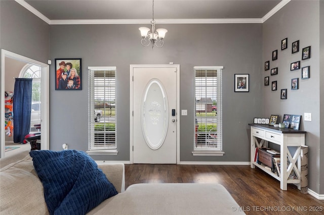 entryway with a healthy amount of sunlight, an inviting chandelier, crown molding, and wood finished floors