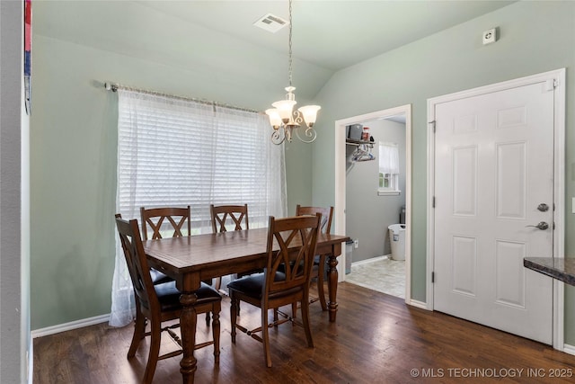 dining space with dark wood-type flooring, visible vents, lofted ceiling, baseboards, and a notable chandelier