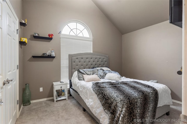 bedroom featuring carpet floors, baseboards, and lofted ceiling