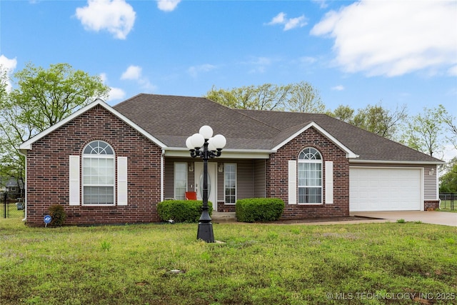 ranch-style home featuring roof with shingles, a front lawn, brick siding, an attached garage, and driveway