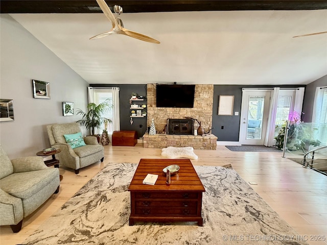 living room with wood finished floors, ceiling fan, and vaulted ceiling