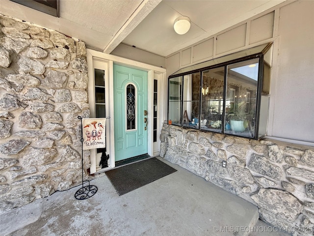 view of exterior entry with stone siding