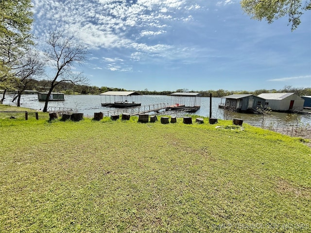 view of yard featuring a water view and a floating dock