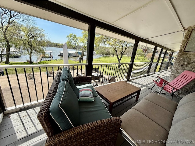 exterior space featuring an outdoor living space and a water view